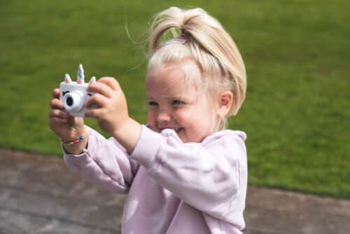 TheZoofamily_camera_unicorn_child_holding_camera_in_hands_in_garden Dječji fotoaparat Zoo Friends Jednorog